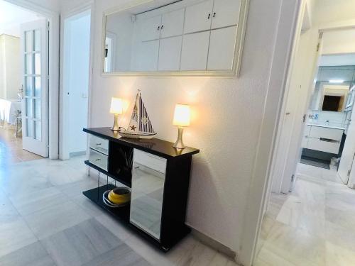 a room with a table with a lamp on it at Beach Apartment 3D - Fuengirola in Fuengirola