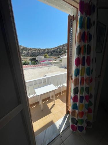 a view of a patio from a window with a table at Matala View in Matala