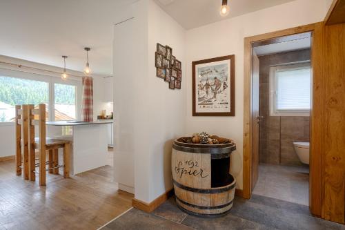 a kitchen and living room with a barrel in the middle of a room at Matterhorn Panorama Apartment in Zermatt