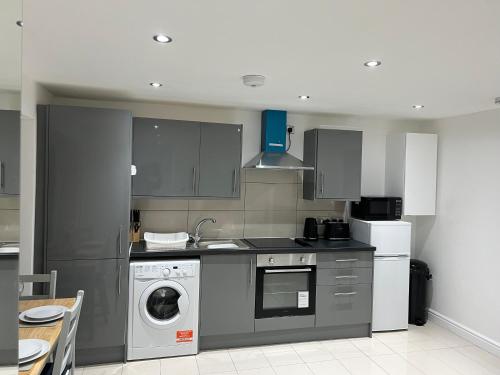 a kitchen with a washer and dryer in it at Lovely holiday home in Southminster in Southminster