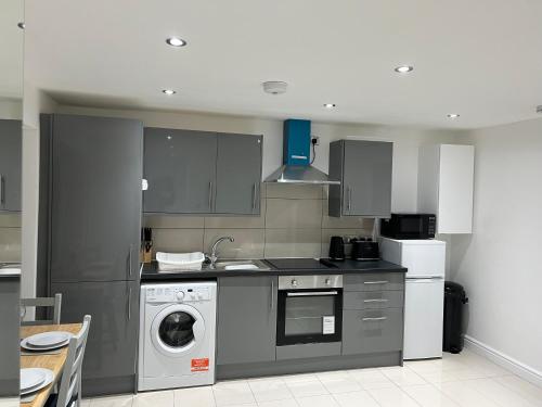 a kitchen with a washer and dryer in it at Lovely 1-bedroom holiday home in Southminster in Southminster