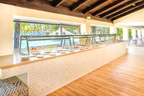 a buffet in a house with a view of the ocean at Coral Costa Caribe Beach Resort - All Inclusive in Juan Dolio