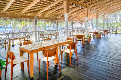 a dining room with tables and chairs in a building at Coral Costa Caribe Beach Resort - All Inclusive in Juan Dolio