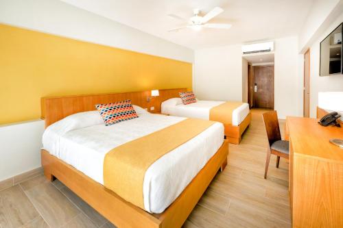 Ein Bett oder Betten in einem Zimmer der Unterkunft Coral Costa Caribe Beach Resort - All Inclusive