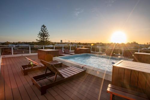 a deck with a swimming pool on top of a building at Hotel Bahamas in Montevideo
