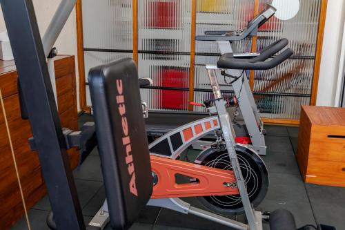 a gym with an exercise bike and a treadmill at Hotel Bahamas in Montevideo
