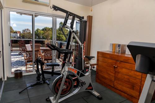 a gym with a bike parked next to a dresser at Hotel Bahamas in Montevideo