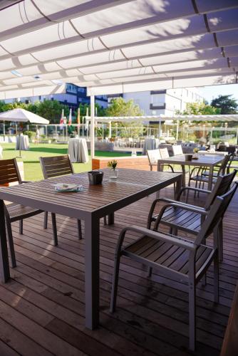 a wooden table and chairs on a deck at Gran Hotel Victoria in Santander