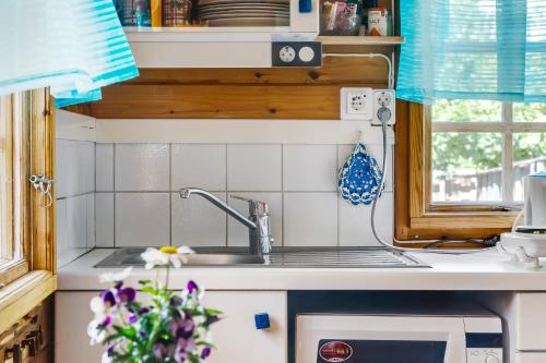 a kitchen counter with a sink and a window at Simple little cottage in a cozy courtyard in Vimmerby in Vimmerby
