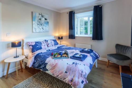 a bedroom with a bed with a tray of food on it at Potters Brook in Framlingham