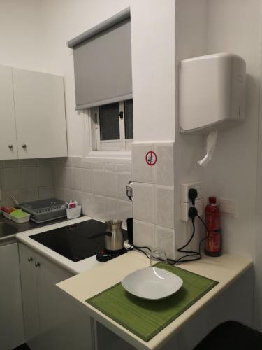 a kitchen with a sink and a plate on a counter at Kalidonia “PANORAMA” STUDIO APARTMENT in İncirli