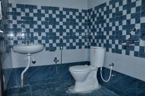 a bathroom with a toilet and a sink at Hotel City View in Bhubaneshwar