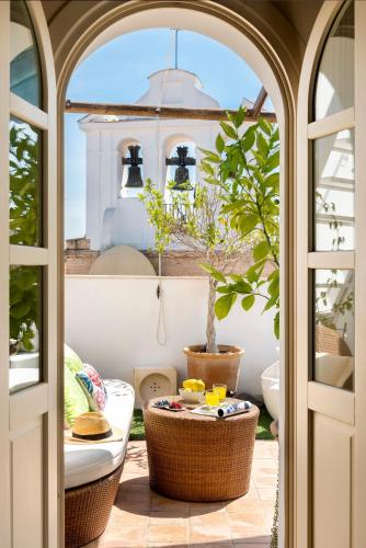 an open door to a patio with a plant at CH Apartments Boutique in Seville