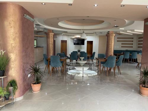 a lobby with a table and chairs in a building at Hotel5E in Plav