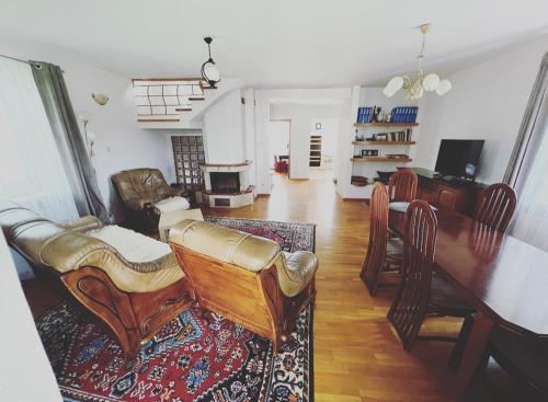 a living room with a table and chairs and a dining room at Mazurski Dom Sucholaski in Wydminy