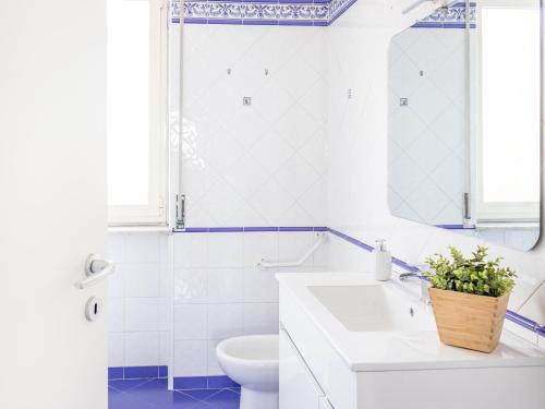 a bathroom with a white sink and a toilet at Panorama Love to Stay in Ercolano