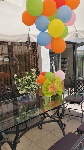 a table with a bunch of balloons on top of it at Hotel Perfect in Yamna