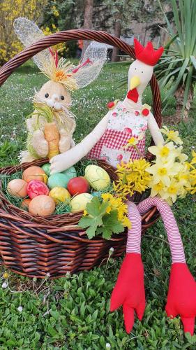 a basket of easter eggs and a chicken and flowers at Hotel Perfect in Yamna