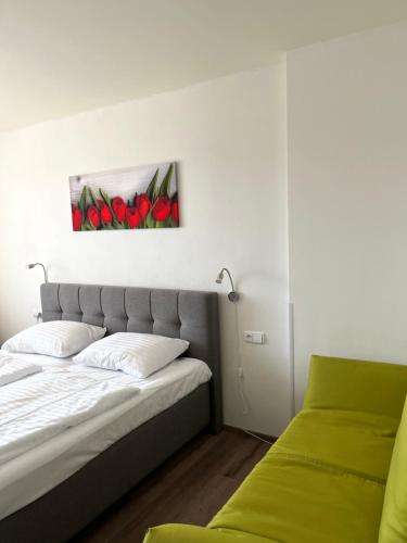 a bedroom with a bed and a picture of red tulips at Ubytování Hanka v pokoji s bakónem C408 in Frymburk
