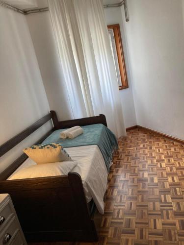 a small bedroom with a bed and a window at Apartamento Trav. Santa Luzia in Mirandela