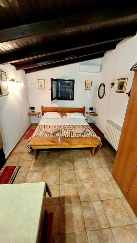a bedroom with a large bed in a room at Apartments Karmen Funtana in Funtana