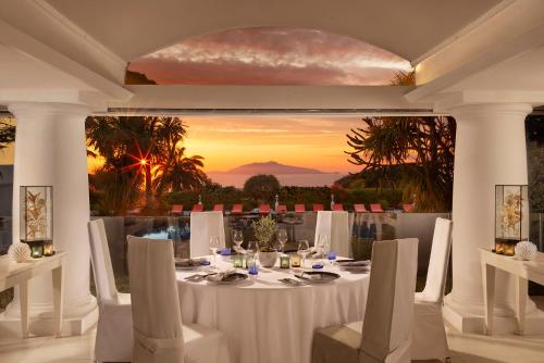 a dining room with a table with a view at Jumeirah Capri Palace in Anacapri
