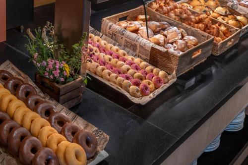 a buffet of pastries and breads on a table at Hotel & Resort Vilar Rural d'Arnes by Serhs Hotels in Arnés
