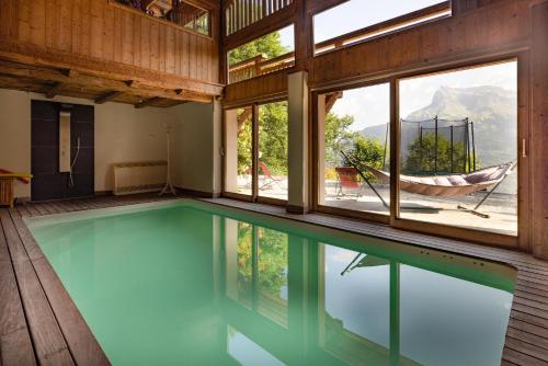 - une piscine intérieure avec un hamac dans une maison dans l'établissement Ferme de Faustine 1 - piscine, à Saint-Gervais-les-Bains