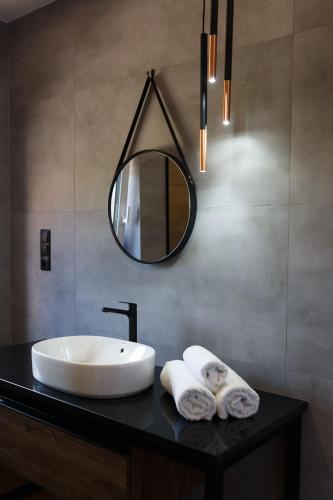 a bathroom with a sink and a mirror on a counter at Agroturystyka Pod Dębem in Łagów