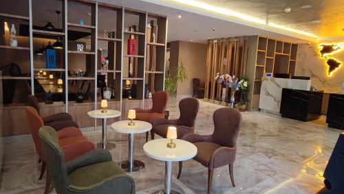 a living room filled with furniture and a table at Pasapark Karatay Hotel in Konya