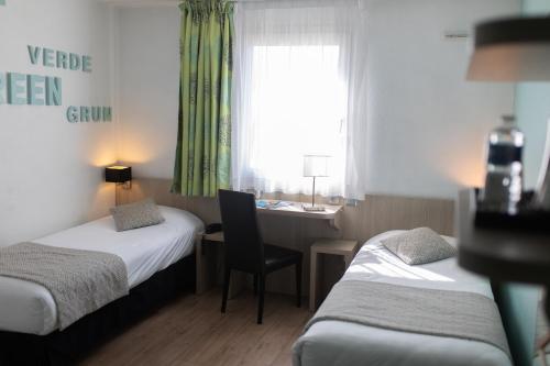 Ένα ή περισσότερα κρεβάτια σε δωμάτιο στο Hôtel Relais d'Étretat
