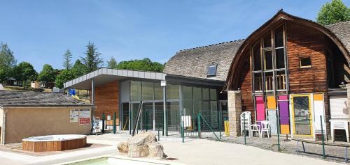 a large building with a large window and a building with a building at Village de Gites le Colombier in Mende