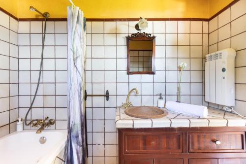 a bathroom with a sink and a tub and a mirror at Casa el Nogal in La Orotava