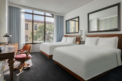 a hotel room with a large bed and a large window at Pendry San Diego in San Diego