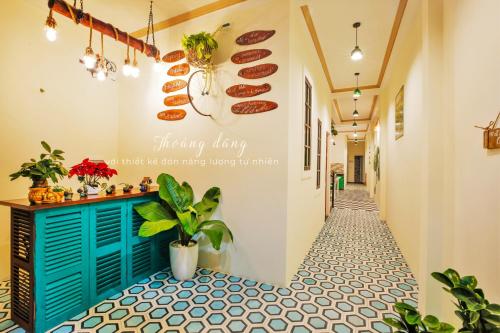 a hallway with a blue door and a table with food on it at Hue Eco Homestay in Hue