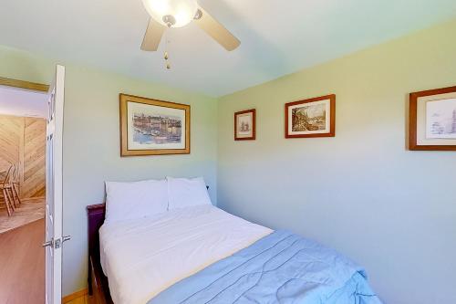 a bedroom with a bed and a ceiling fan at The Summer House in Onekama