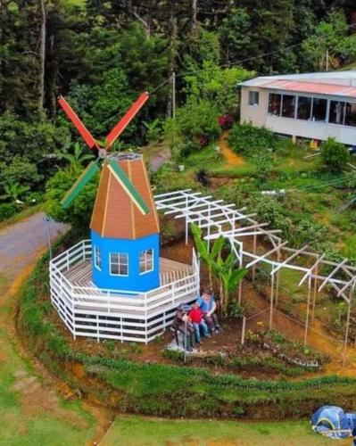 a model of a house with a windmill in a yard at Hotel Vistas del Cielo in Cartago