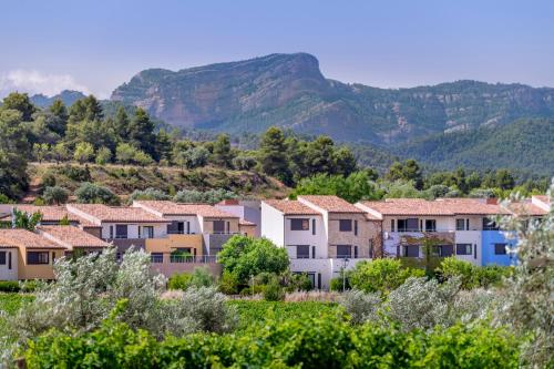 ein Dorf mit Häusern und Bergen im Hintergrund in der Unterkunft Hotel Vilar Rural d'Arnes by Serhs Hotels in Arnés