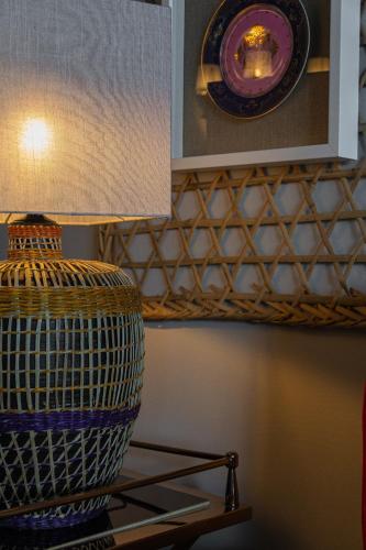 a vase sitting on a shelf with a lamp at Villa Cerrado das Fontainhas SPA in Sintra