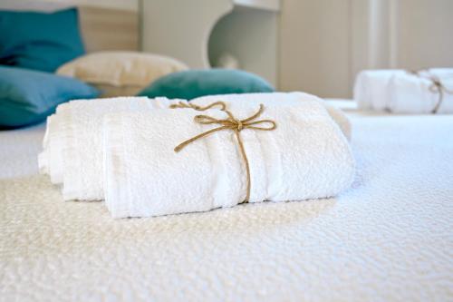 two towels are sitting on top of a bed at Macchia Piccinna in Maruggio