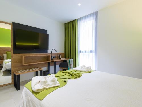 a hotel room with a bed and a television at Hotel MG Poniente in Las Palmas de Gran Canaria