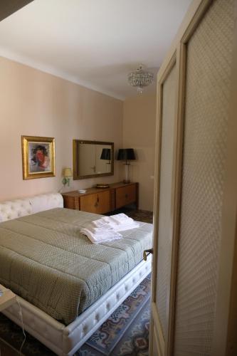 a bedroom with a bed and a mirror at Marianna in Isnello