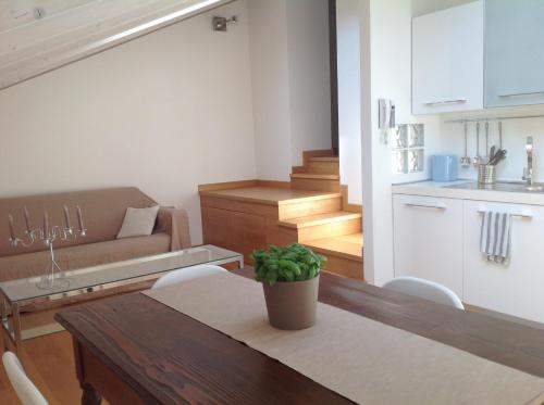 a kitchen and living room with a table and a couch at Apartment 23 in Como