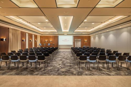 a conference room with chairs and a projection screen at Crowne Plaza Budapest by IHG in Budapest