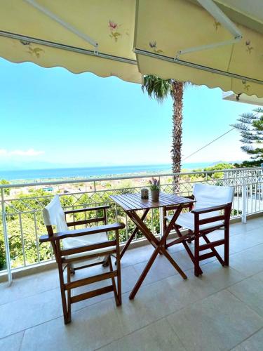 a table and chairs on a balcony with the ocean at Cosy apartment with Great Views in Longá