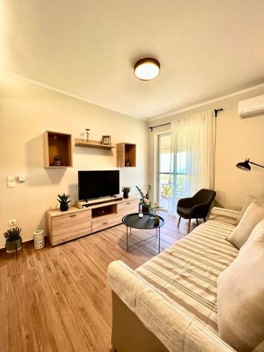 a living room with a couch and a flat screen tv at Cosy apartment with Great Views in Longá