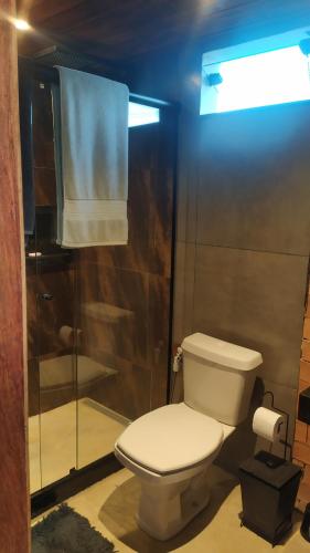 a bathroom with a toilet and a shower at Loft Antunes in Maricá