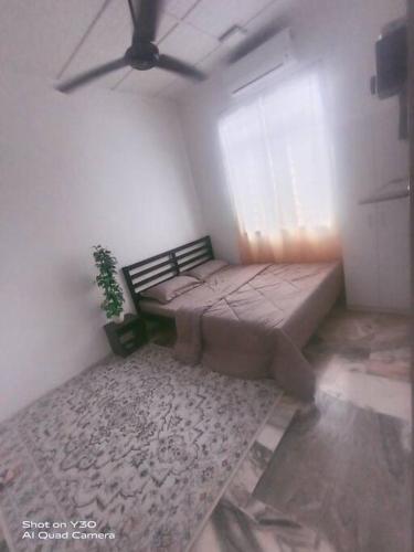 Кровать или кровати в номере Imani Homestay Beach Gateway Bagan Lalang