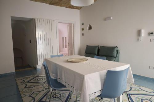 a dining room with a table and blue chairs at Vico Nove in Lanciano