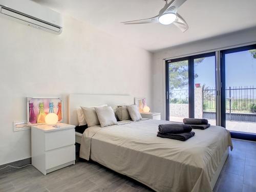 Schlafzimmer mit einem großen Bett und einem Deckenventilator in der Unterkunft Villa with Private Pool - 6409 in El Carmolí